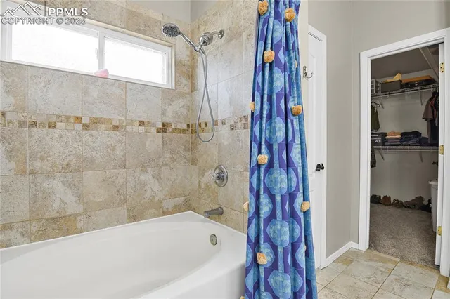 a bathroom with a bathtub and a shower