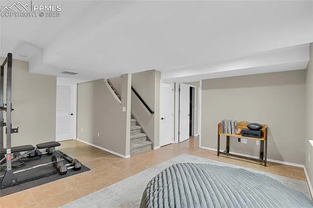 a bedroom with furniture and a wooden floor