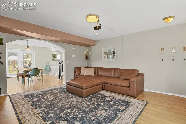 a living room with furniture and a wooden floor