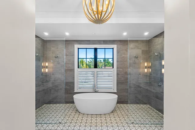 a bathroom with a sink a toilet a window and vanity