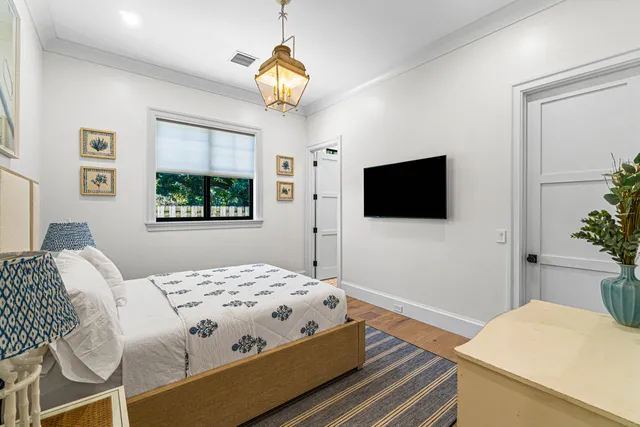 a bedroom with a bed and a flat screen tv