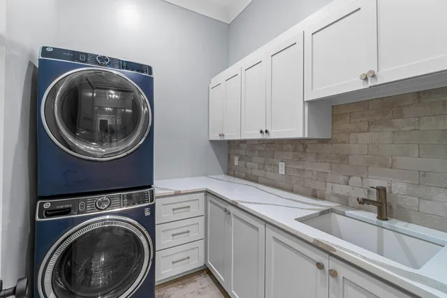 a utility room with sink dryer and washer