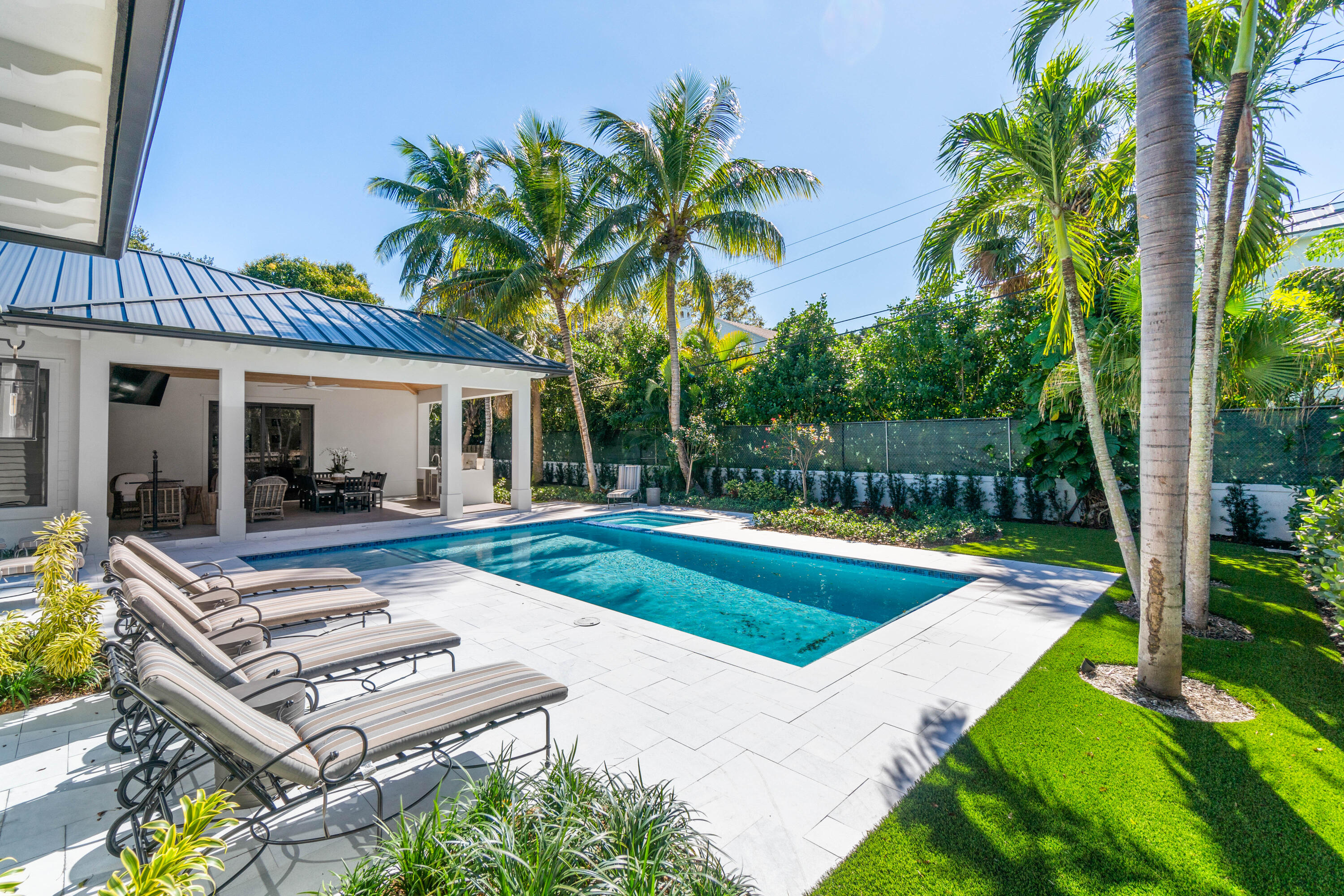 18 Northwest 15th Street Delray Beach, FL 33444 - Photo 2 of 29 a view of a house with swimming pool lawn chairs and a yard