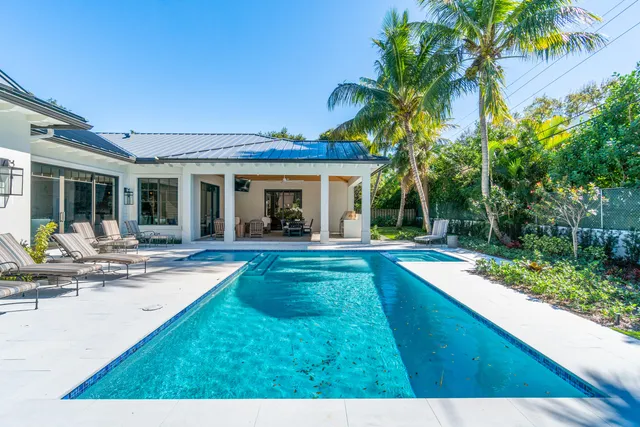a view of a house with swimming pool and a porch