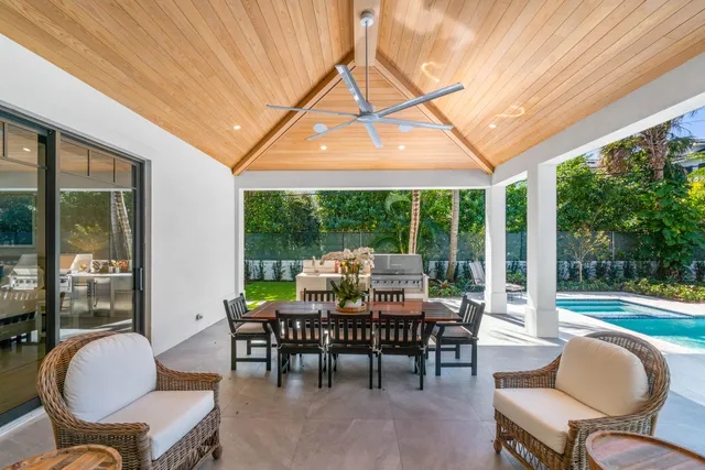 a view of a patio with a dining table and chairs