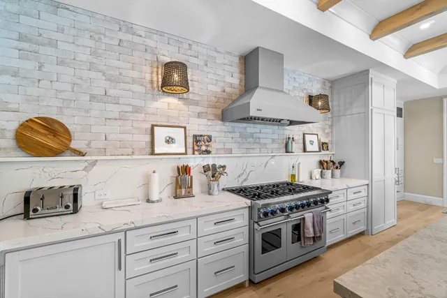 a kitchen with stainless steel appliances granite countertop a stove and a sink