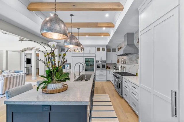 a kitchen with stainless steel appliances kitchen island granite countertop a table and chairs in it