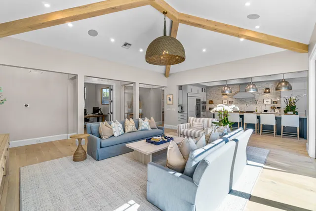 a living room with furniture and chandelier