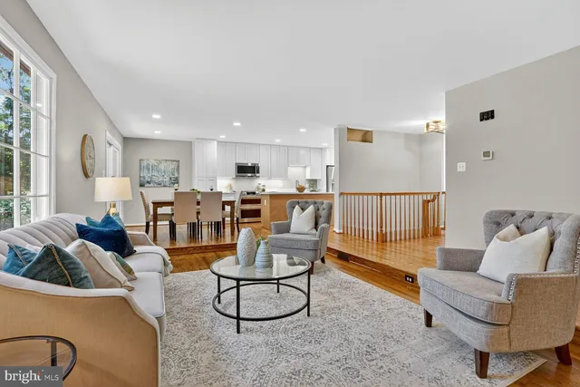 a living room with furniture and kitchen view