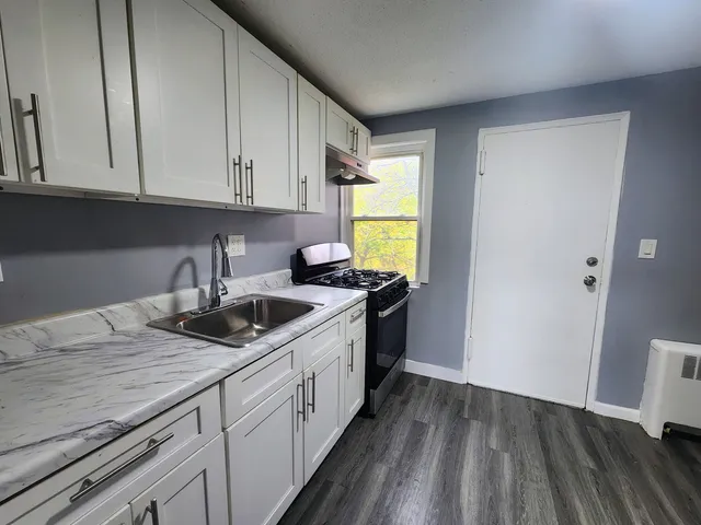 a kitchen with a sink and cabinets