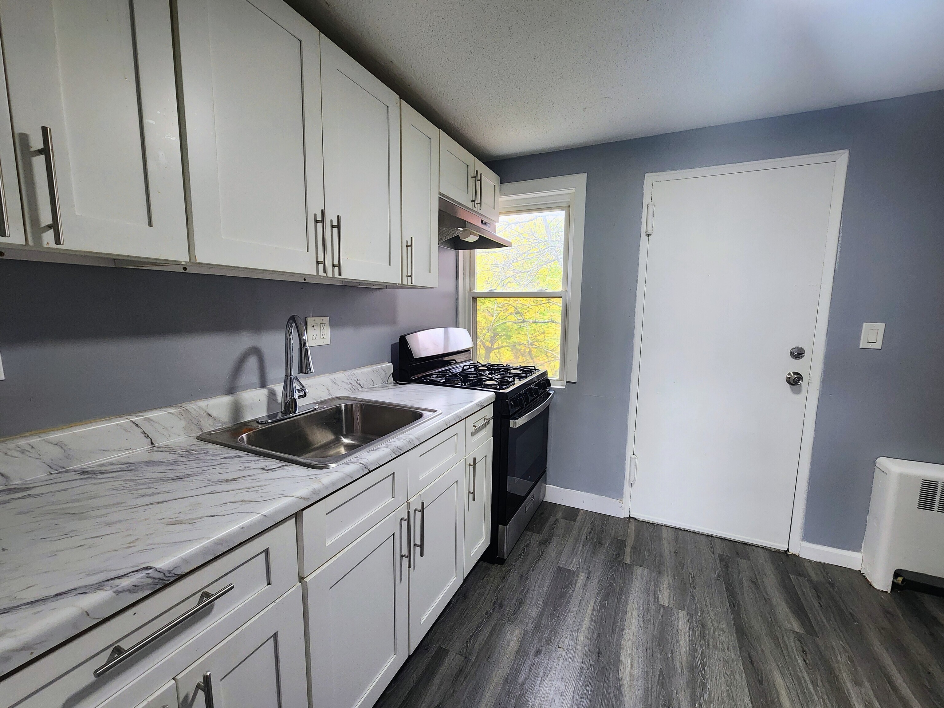 936 Wethersfield Avenue, Unit 3 Hartford, CT 06114 - Photo 1 of 5 a kitchen with a sink and cabinets