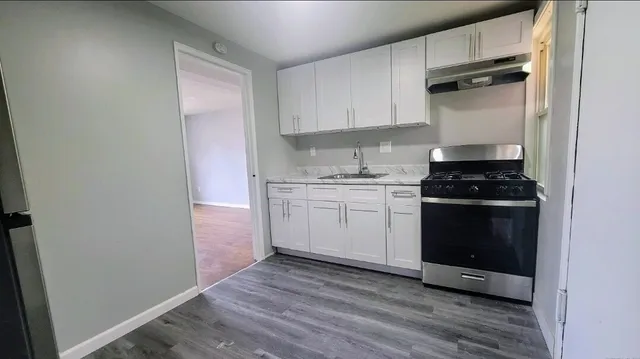 a kitchen with a sink stove and cabinets