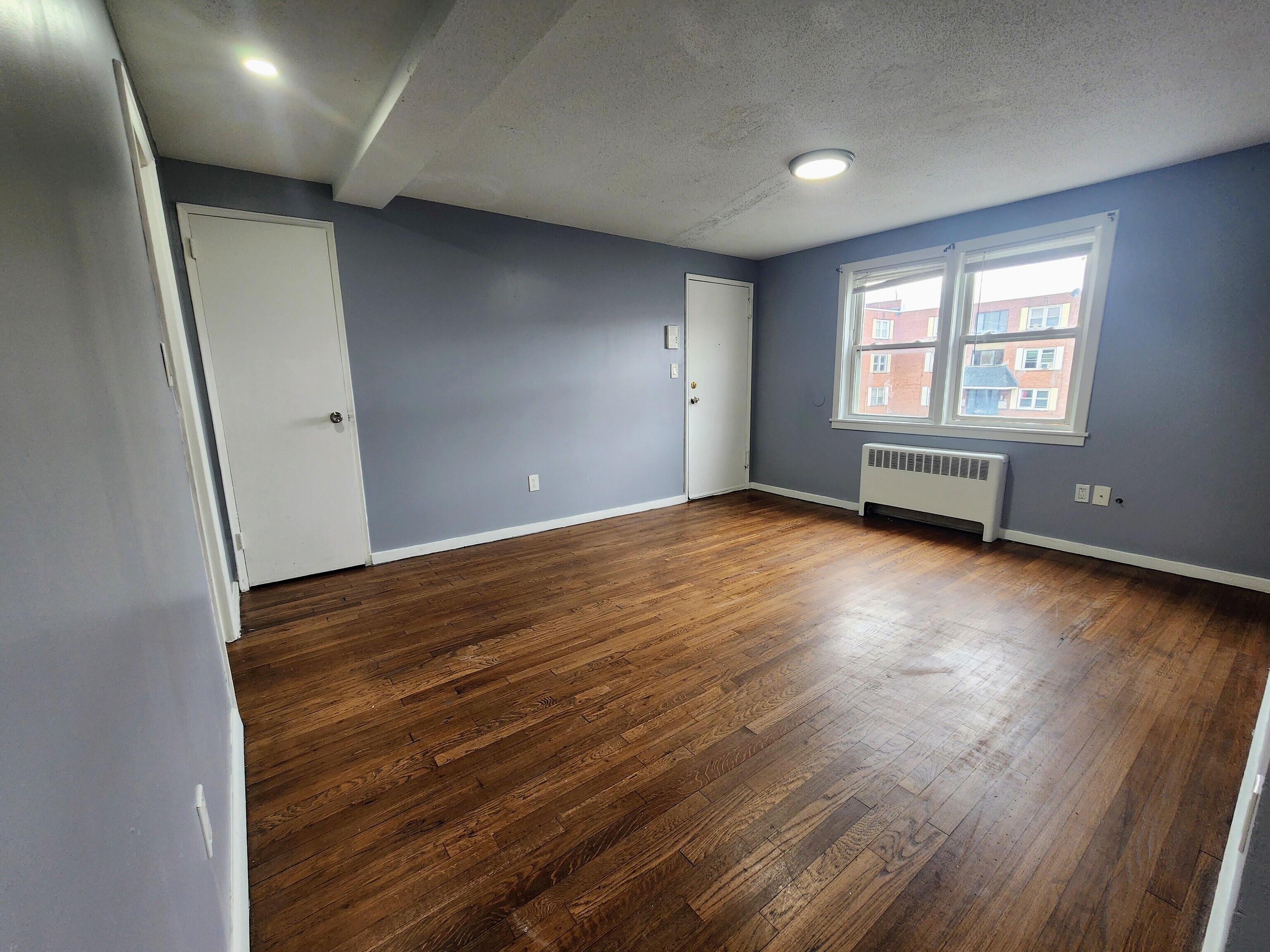 936 Wethersfield Avenue, Unit 3 Hartford, CT 06114 - Photo 3 of 5 an empty room with wooden floor and windows