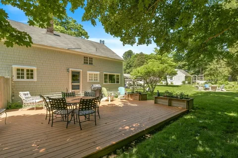 a backyard of a house with table and chairs