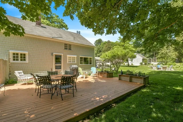a backyard of a house with table and chairs