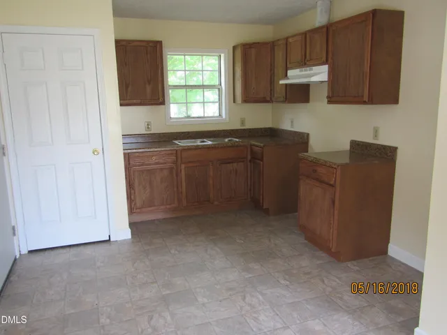 a kitchen with cabinets and window