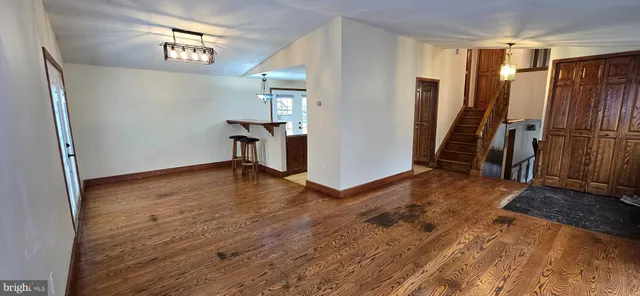 a view of a room with furniture and wooden floor