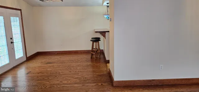 a view of a kitchen with furniture and wooden floor