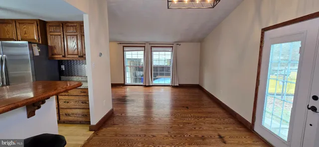 a kitchen with stainless steel appliances granite countertop a refrigerator a stove and a sink