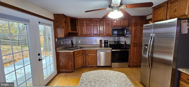 a kitchen with a sink a stove and cabinets