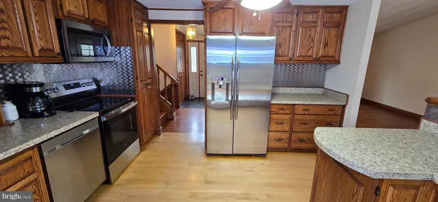 a view of a livingroom with stairs and furniture