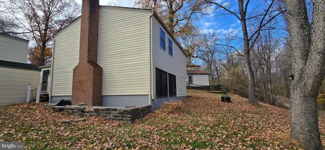 a view of hallway with wooden floor and stairs