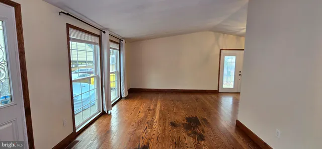 a view of empty room with a kitchen