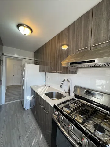 a kitchen with a stove and a refrigerator