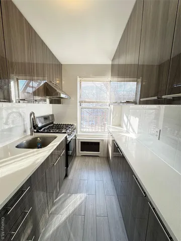 a kitchen with a sink a stove and cabinets