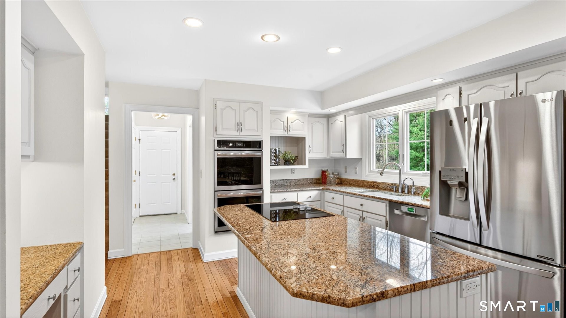 138 Cold Spring Road Avon, CT 06001 - Photo 12 of 36 Kitchen with refinished hardwood floors, SS appliances & granite.