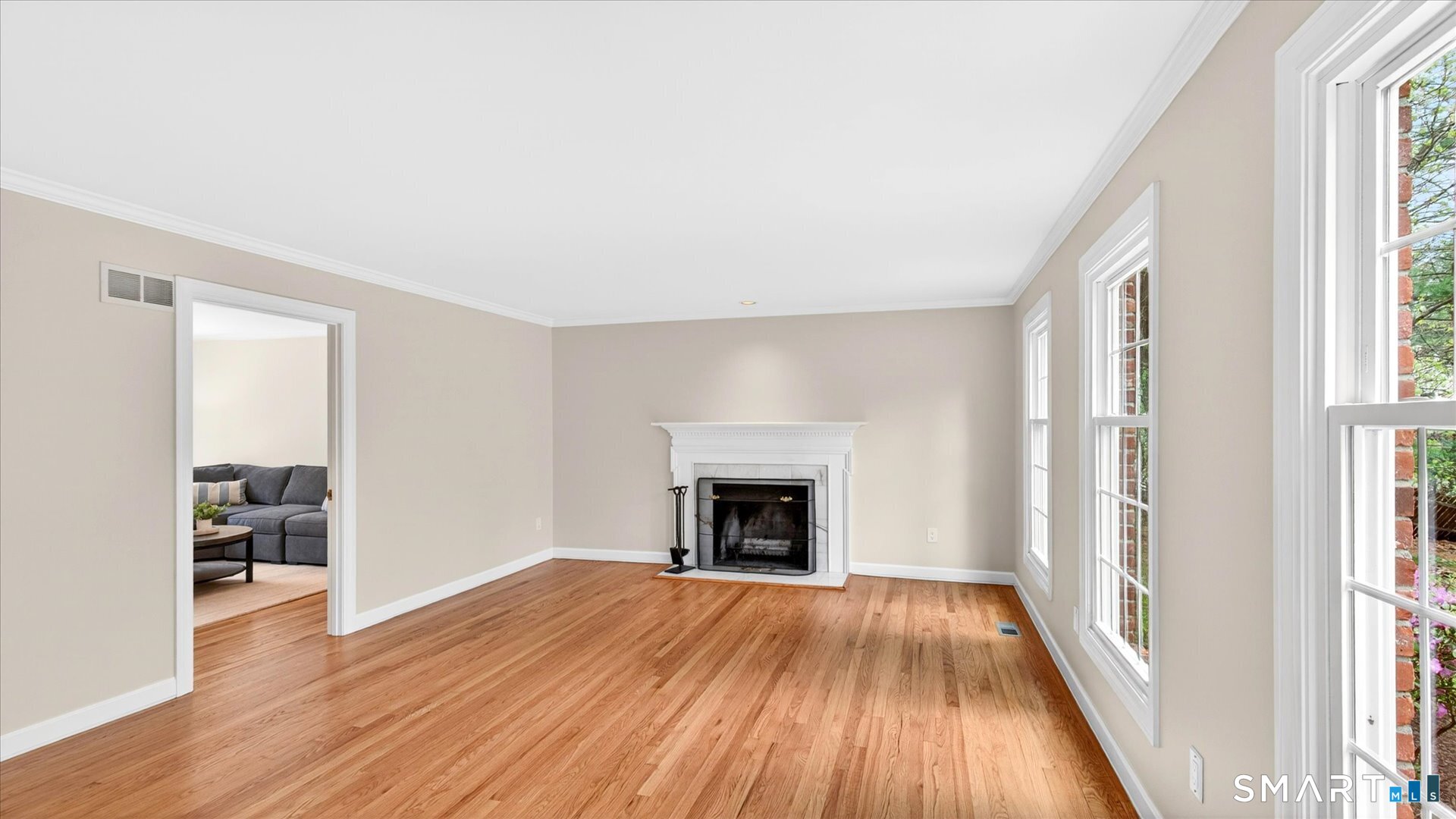 138 Cold Spring Road Avon, CT 06001 - Photo 5 of 36 Spacious formal living room with hardwood floors, wood burning fireplace, and french door that opens to the family room.