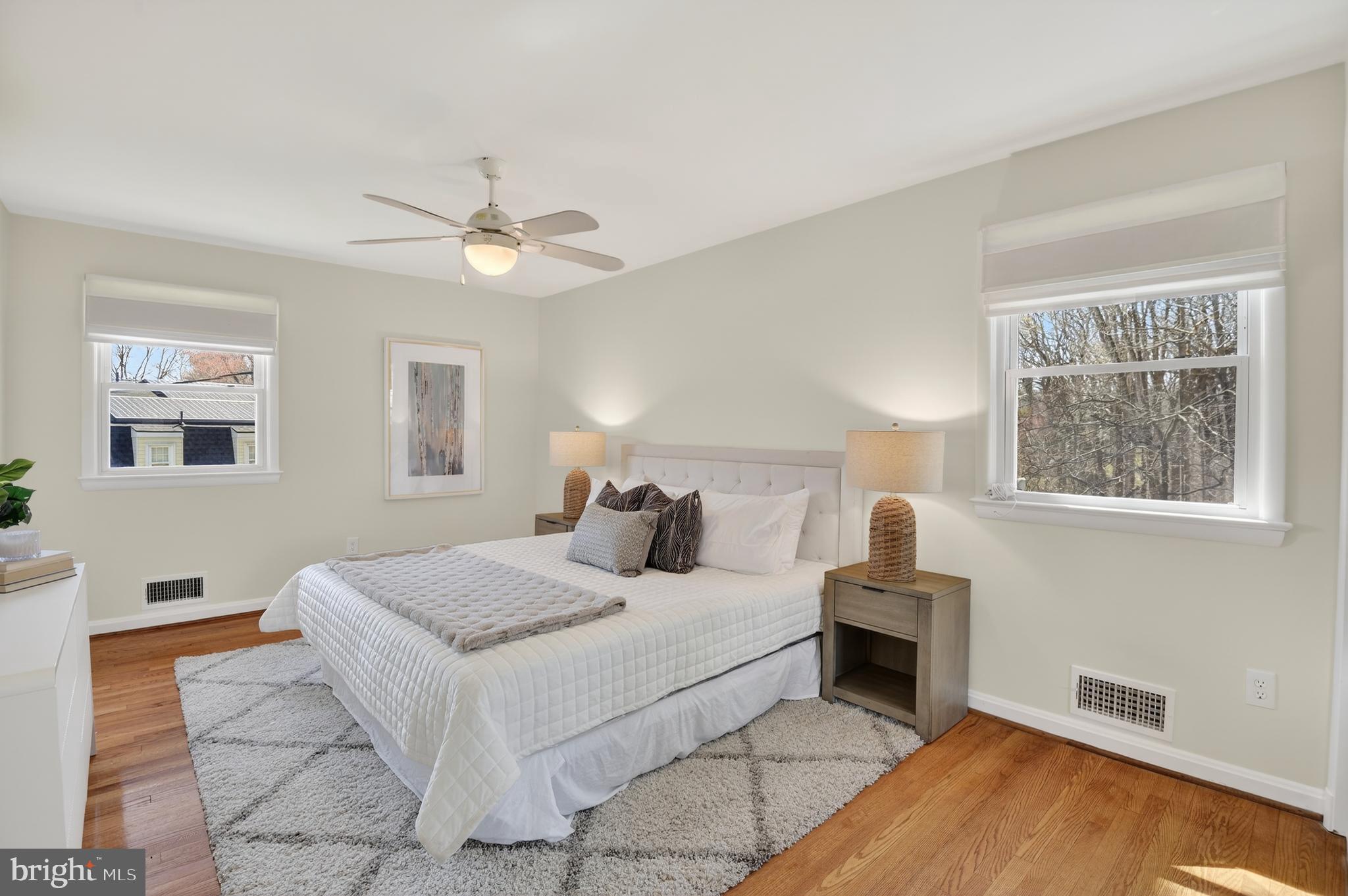 11004 Oakwood Street Silver Spring, MD 20901 - Photo 18 of 35 a bedroom with a large bed chandelier and a window