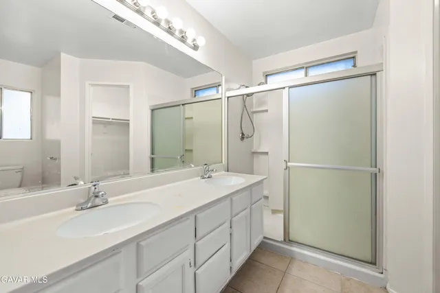 a bathroom with a double vanity sink mirror and double