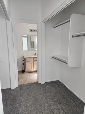 a view of a hallway with closet and cabinet