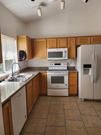 a kitchen with a stove sink and a refrigerator