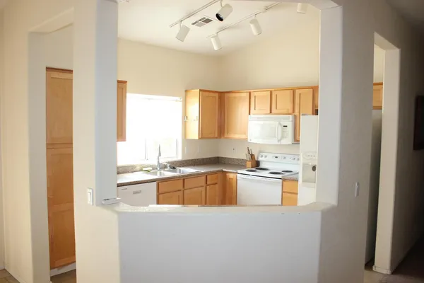 a view of a kitchen with a sink and a window
