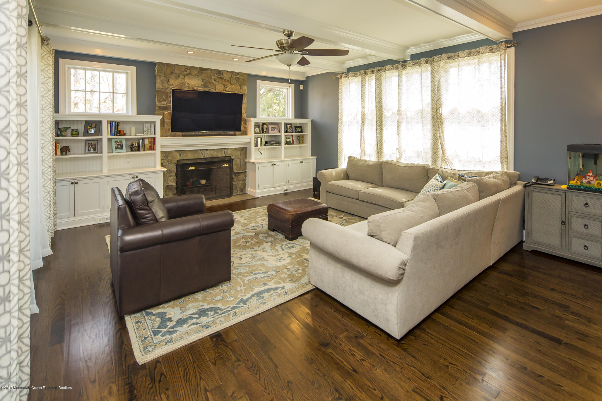 3 Evergreen Drive Rumson, NJ 07760 - Photo 12 of 37 a living room with furniture a flat screen tv and a fireplace