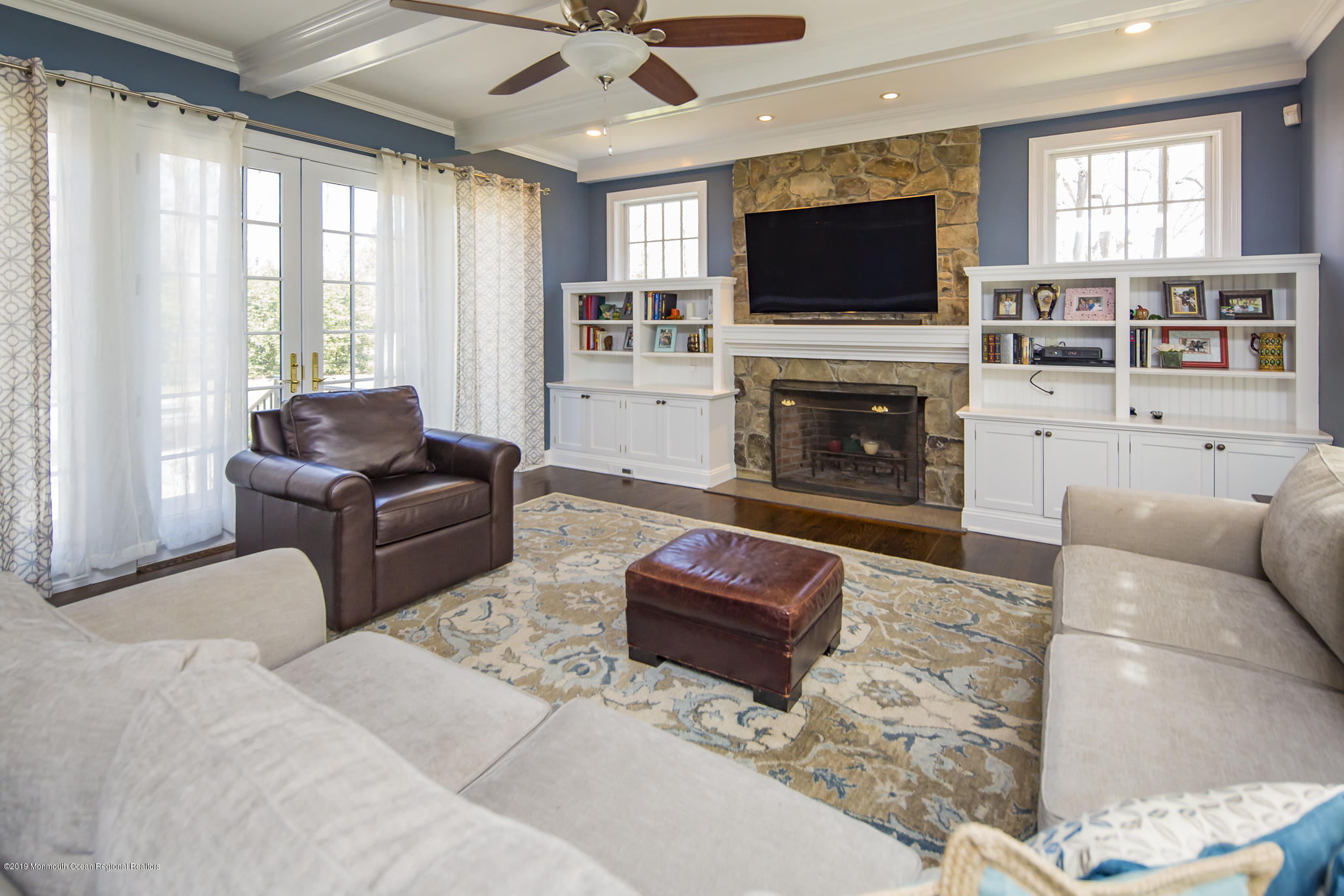 3 Evergreen Drive Rumson, NJ 07760 - Photo 13 of 37 a living room with furniture a fireplace and a flat screen tv