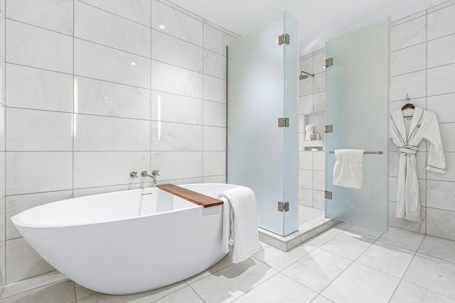 a bathroom with a tub and shower