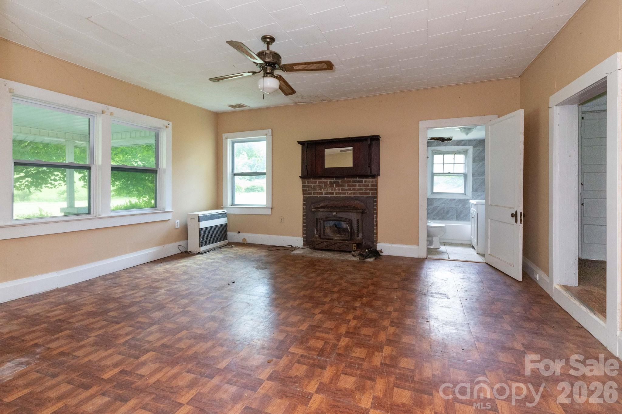 4085 Jacks Creek Road Burnsville, NC 28714 - Photo 9 of 24 a view of empty room with a fireplace and a window
