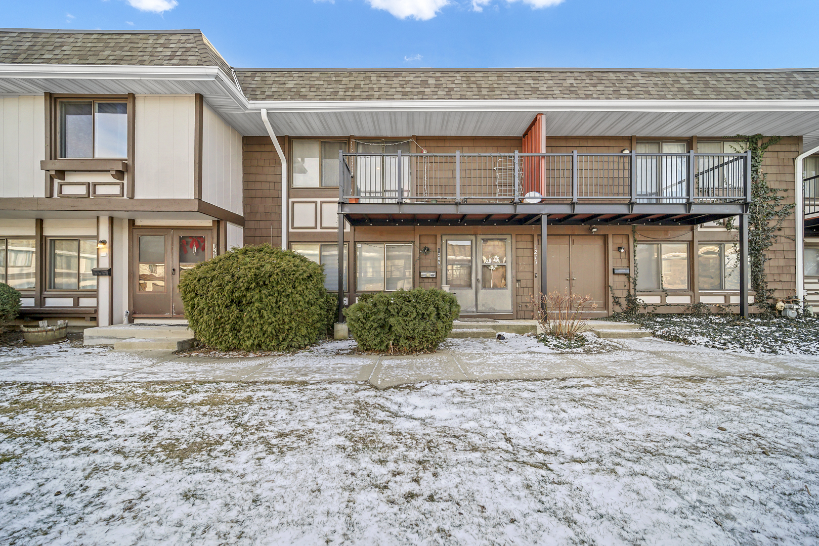 a front view of a house with a garden