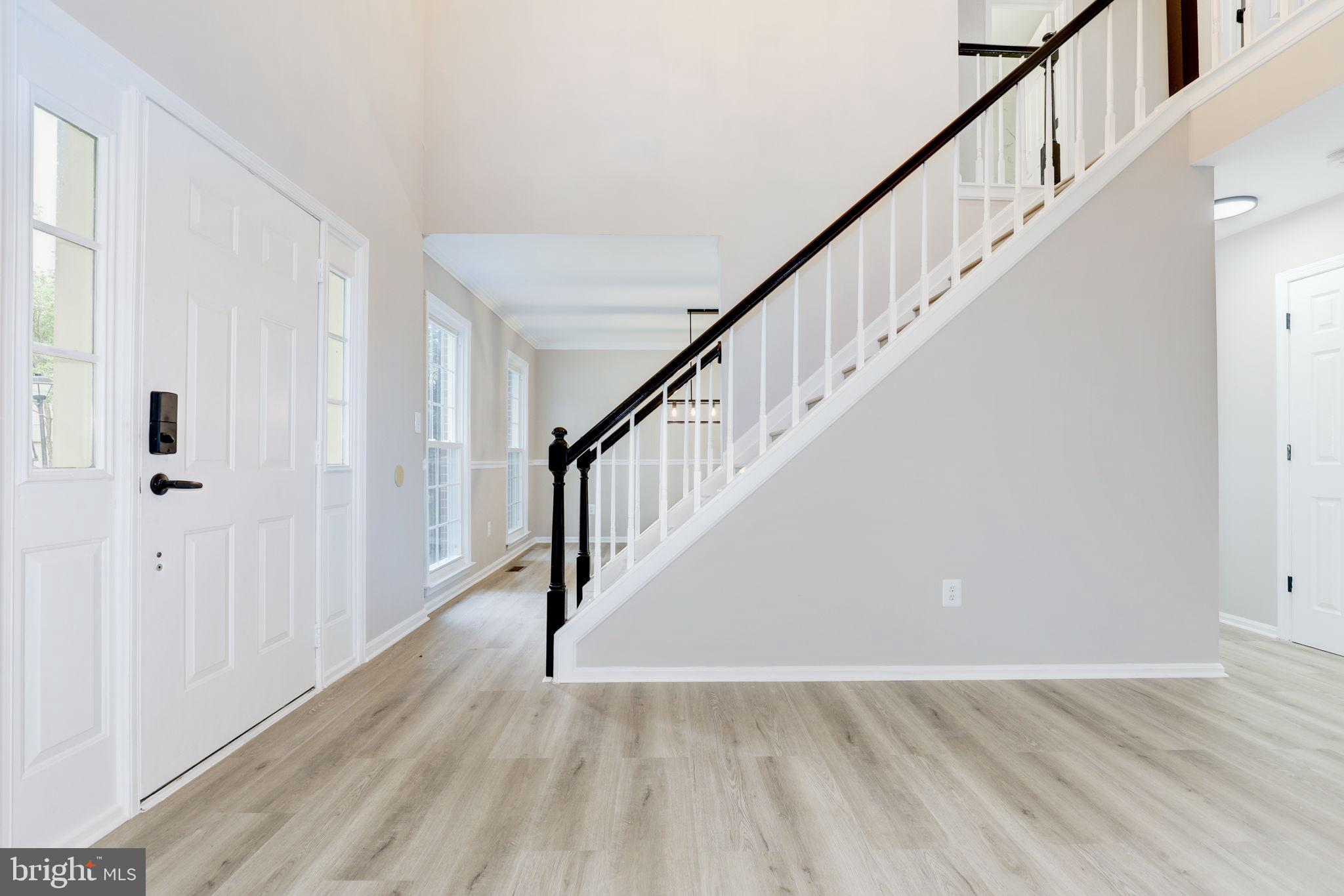 14422 Old Stage Road Bowie, MD 20720 - Photo 2 of 65 a view of staircase with wooden floor and white walls
