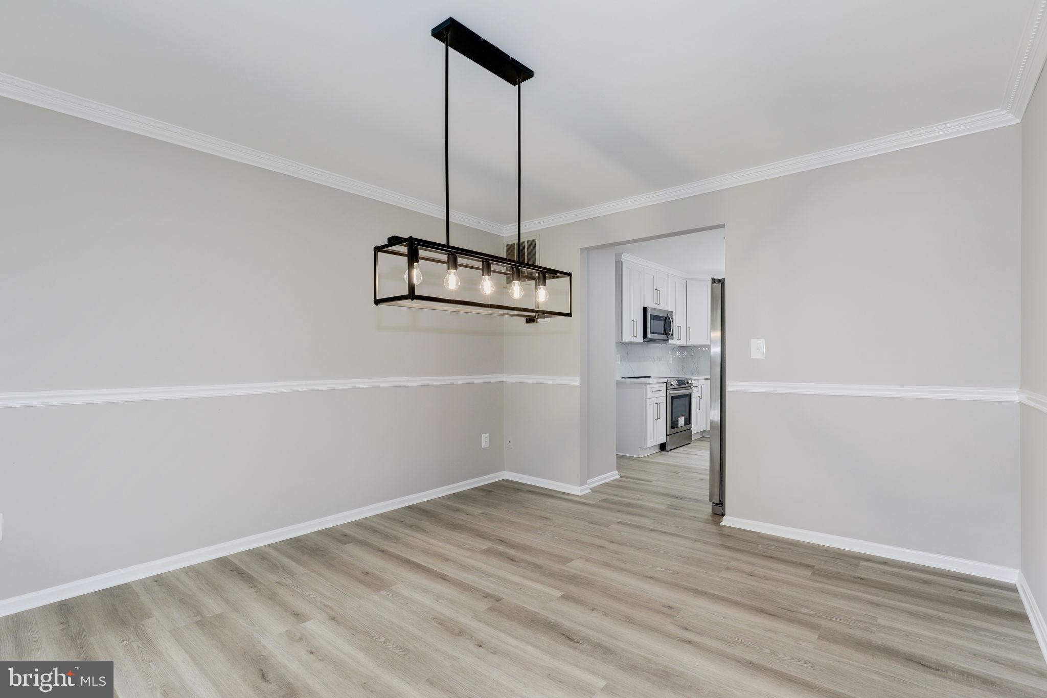 14422 Old Stage Road Bowie, MD 20720 - Photo 22 of 65 a view of empty room with wooden floor and ceiling fan