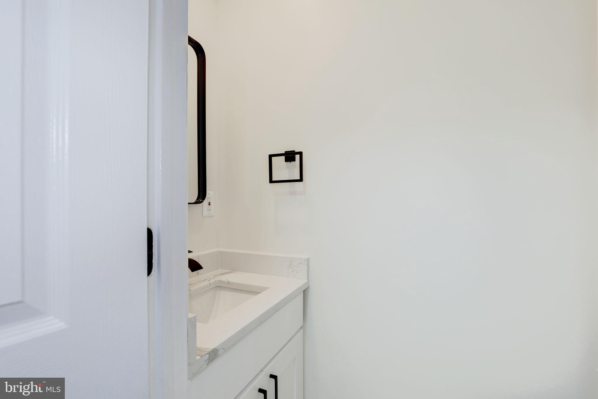 14422 Old Stage Road Bowie, MD 20720 - Photo 23 of 65 a bathroom with a sink and a mirror