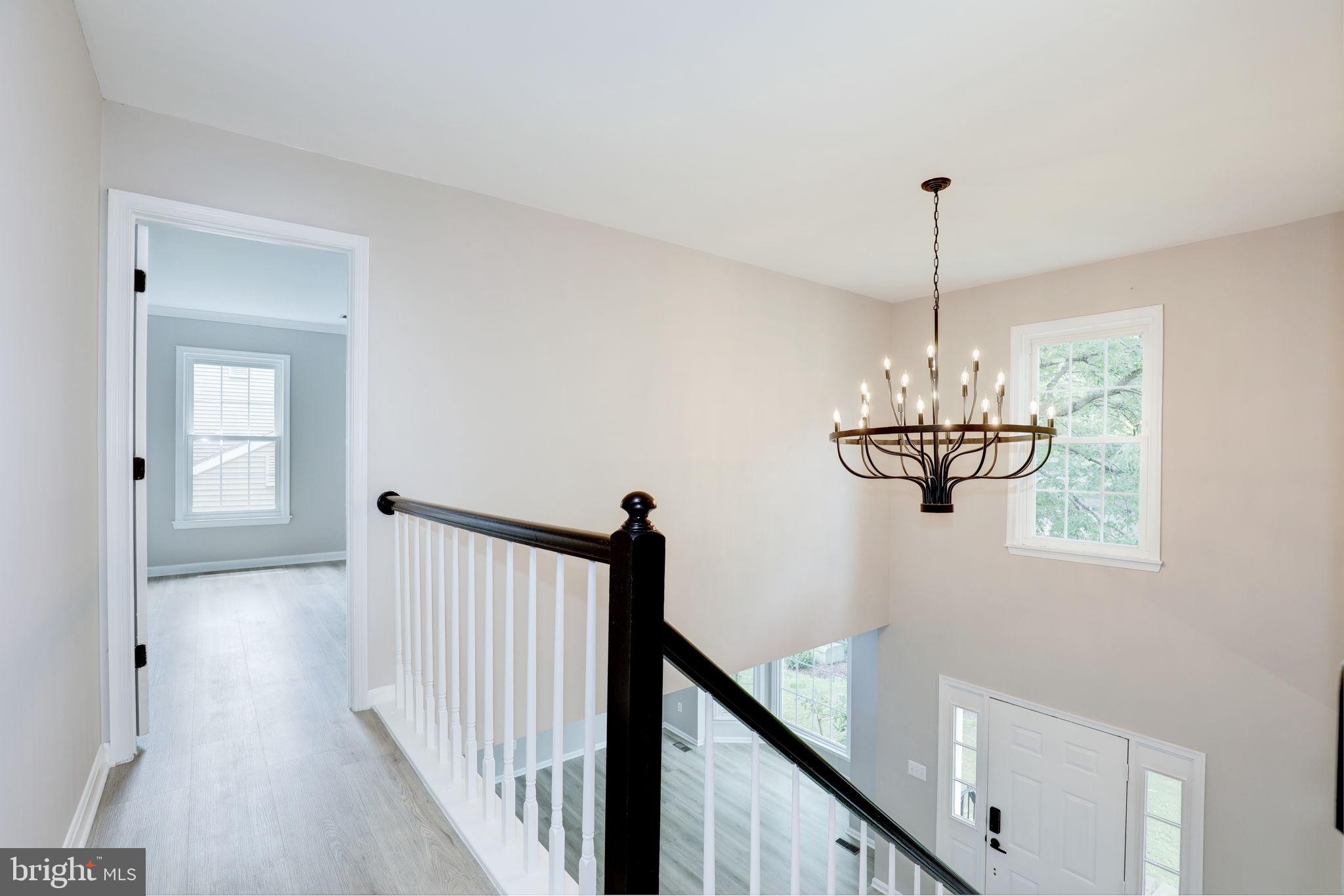 14422 Old Stage Road Bowie, MD 20720 - Photo 25 of 65 a view of a hallway with a chandelier