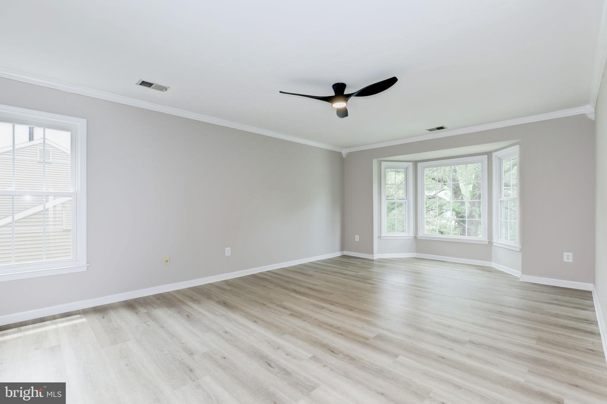14422 Old Stage Road Bowie, MD 20720 - Photo 27 of 65 a view of an empty room with wooden floor and a window