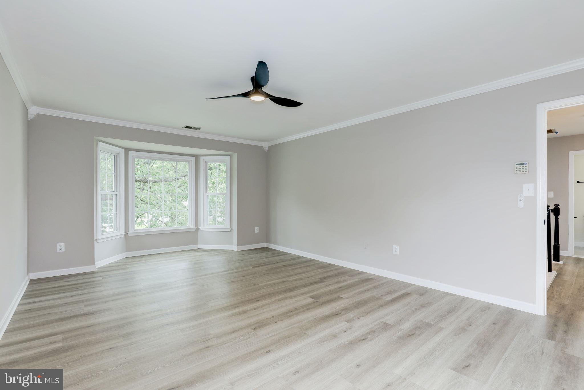 14422 Old Stage Road Bowie, MD 20720 - Photo 28 of 65 a view of an empty room with wooden floor and a window