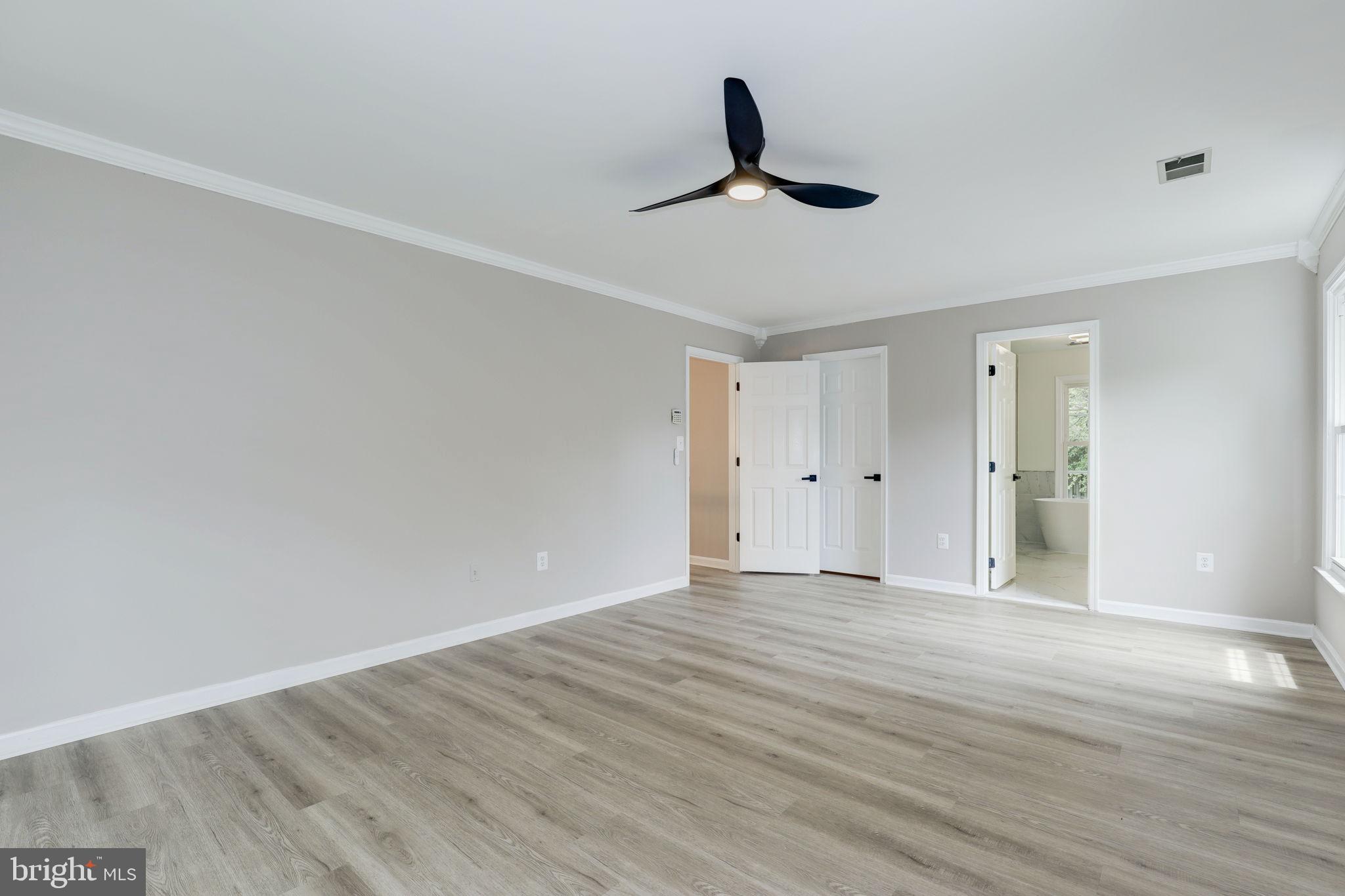 14422 Old Stage Road Bowie, MD 20720 - Photo 29 of 65 a view of empty room with wooden floor and ceiling fan
