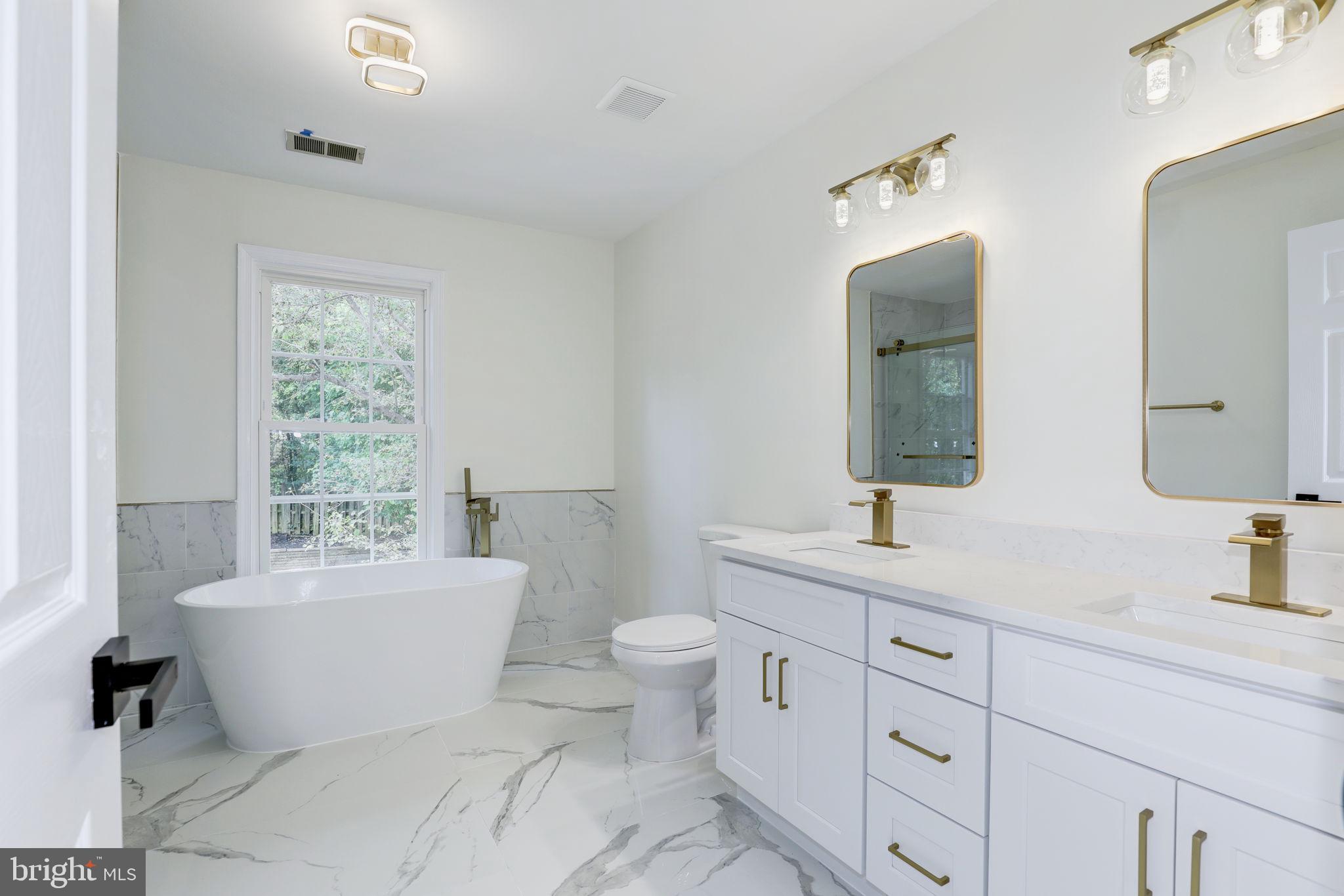 14422 Old Stage Road Bowie, MD 20720 - Photo 30 of 65 a bathroom with a toilet sink and mirror