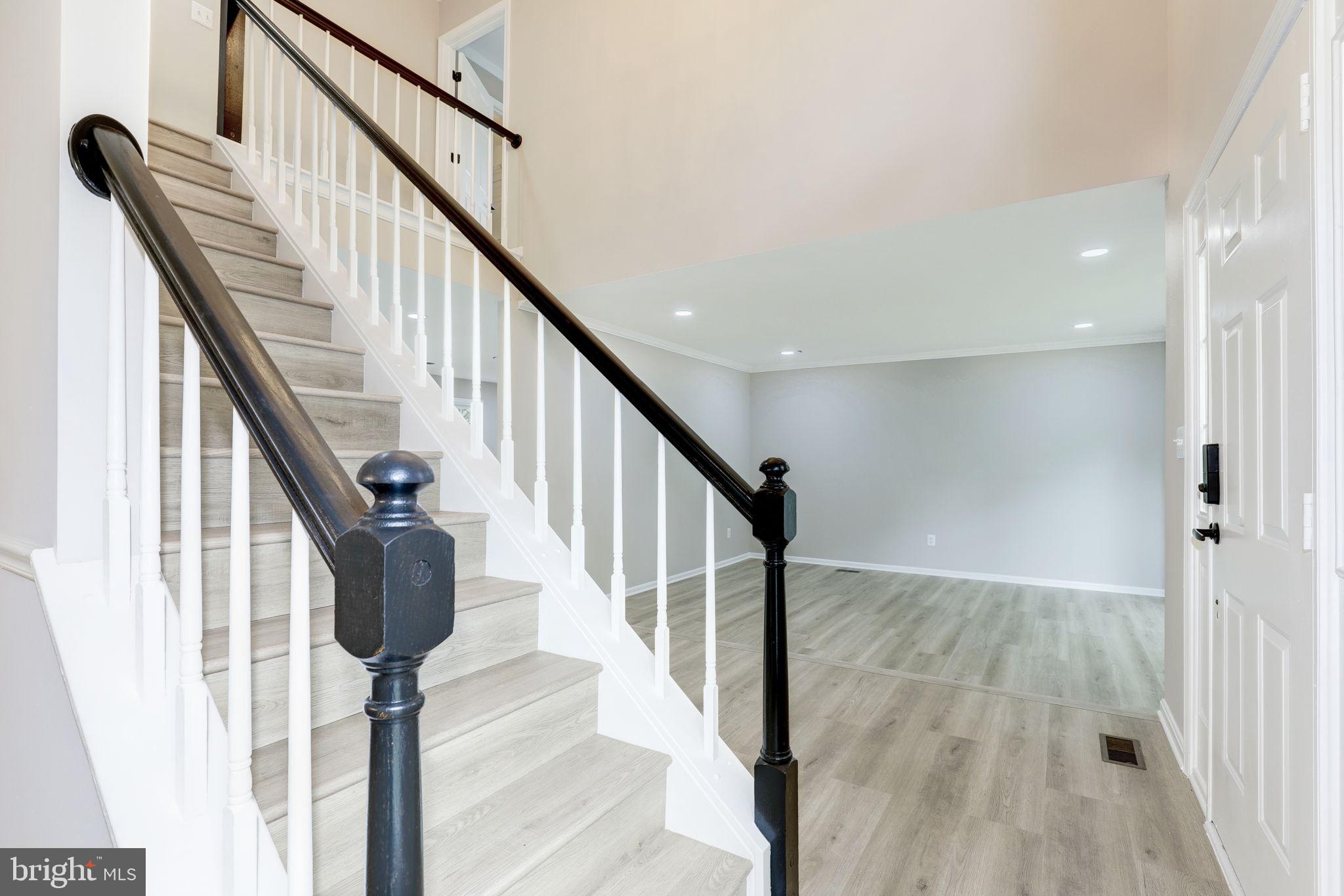 14422 Old Stage Road Bowie, MD 20720 - Photo 3 of 65 a view of entryway with wooden floor and stairs